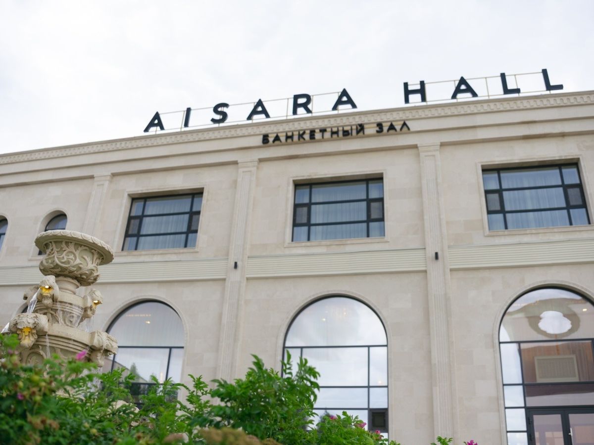 Фасад AiSara Hall крупным планом: вывеска и арочные окна